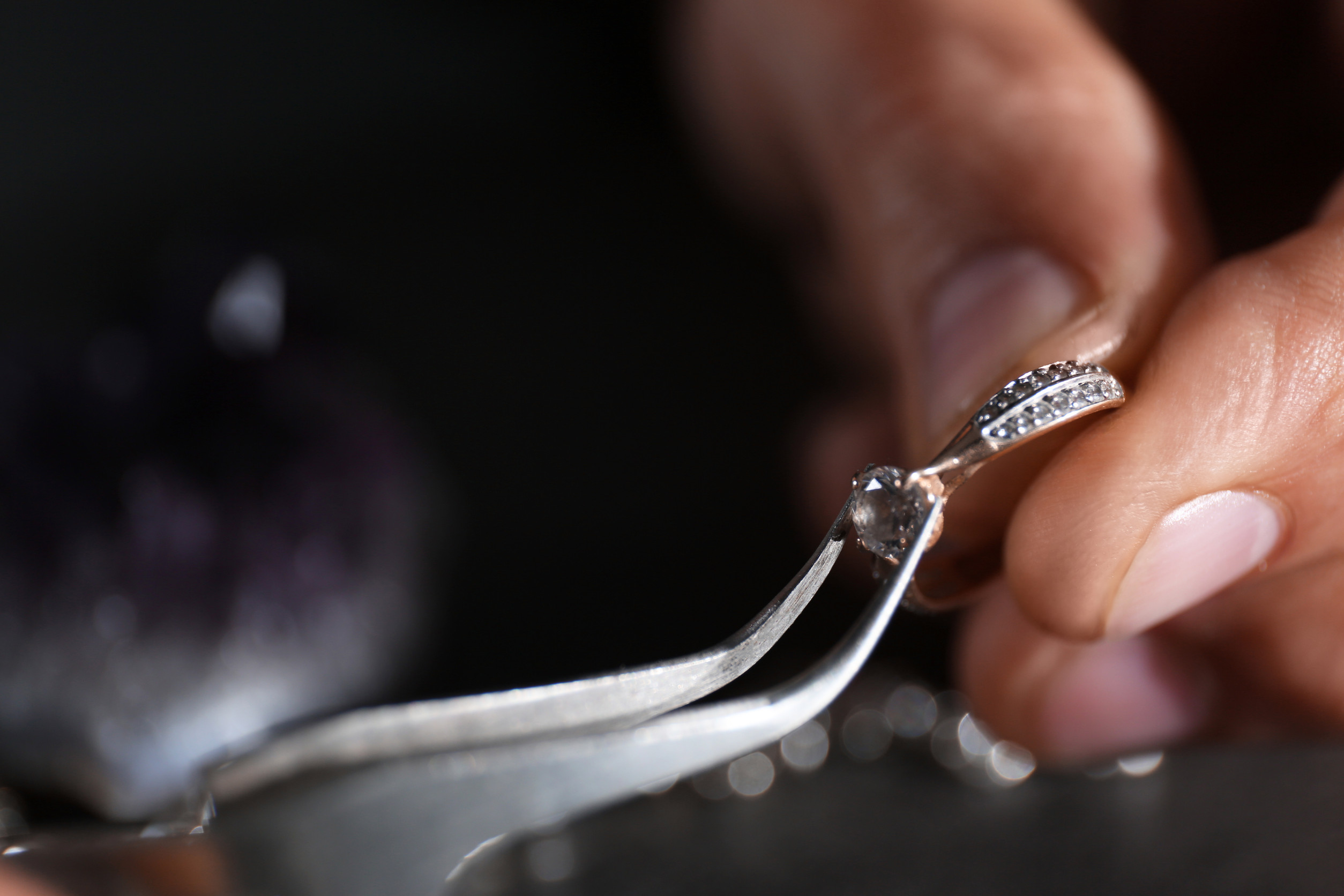 A man working on jewelry repair.